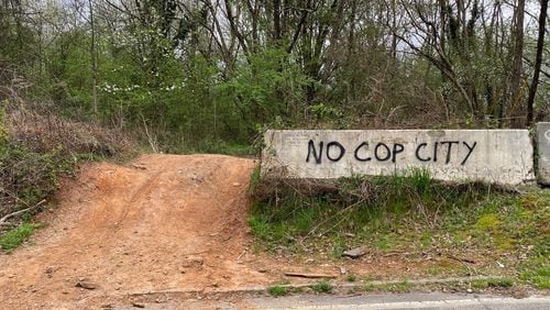 Graffiti near a dirt part off Key Road in southern DeKalb County, just outside the property where the Atlanta Police Foundation plans to build a new public safety training center.