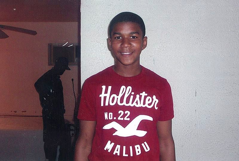 In this undated family photo, Trayvon Martin poses for a family photo. The family of the black teenager fatally shot by a white neighborhood watch volunteer arrived at Sanford City Hall Friday evening March 16, 2012 to listen to recordings of 911 calls police previously refused to release. Police agreed to release the recordings earlier that afternoon. Officials are allowing the family of 17-year-old Trayvon Martin to hear the recordings before making them public. Martin's parents previously sued to have the recordings released. A hearing for the case was scheduled for Monday. Martin was fatally shot last month as he returned to a Sanford home during a visit from Miami. His parents, Tracy Martin and Sybrina Fulton, accused Sanford police of botching the investigation and criticized them for not arresting 28-year-old George Zimmerman, who says he shot Trayvon Martin in self-defense. Martin was not armed. They say the police department hasn't arrested Zimmerman because he is white and their son was black.