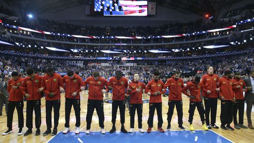 The Atlanta Hawks lock arms during the national anthem before an NBA basketball game against the Dallas Mavericks in Dallas, Wednesday, Oct. 18, 2017. (AP Photo/LM Otero)