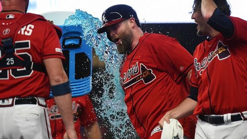 Brian McCann #16 of the Atlanta Braves celebrates with his teammates after hitting a walk off single in the bottom of the 9th to defeat the Miami Marlins at SunTrust Park on July 05, 2019 in Atlanta, Georgia. (Photo by Logan Riely/Getty Images)
