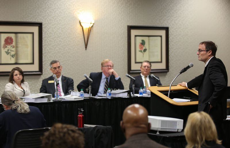Lawyer Bryan Sells speaks to a witness as members of the State Election Board listen during a hearing held by the State Election Board earlier this year. The board made decisions on 98 cases this past week. (Photo/Austin Steele for The Atlanta Journal-Constitution) 