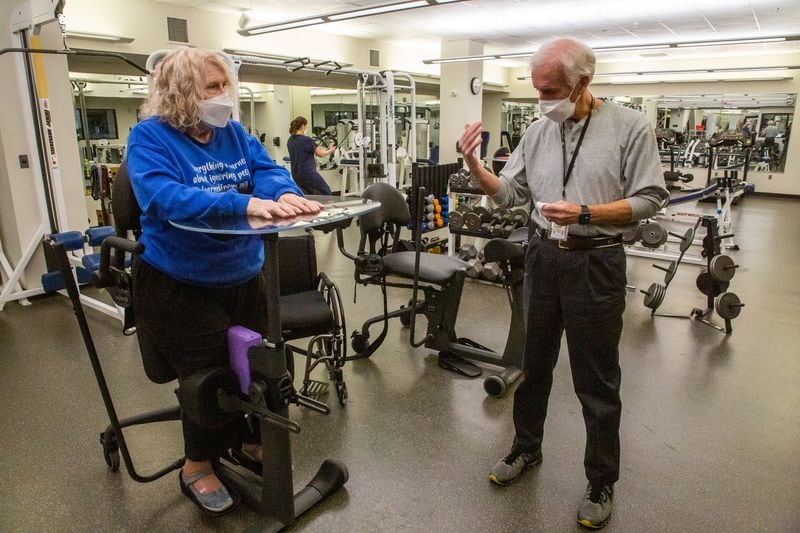 Volunteer Fitness Buddy Doyle Mote works with patient Donna Luttrell during her morning workout at the Shepherd Center Monday, December 13, 2021.  STEVE SCHAEFER FOR THE ATLANTA JOURNAL-CONSTITUTION