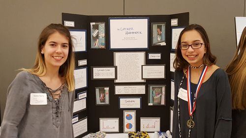 The Locker Hammock inventor, Katie Barry (left), and teammate, Olivia Quern, stand next to their display explaining the concept, design process and marketability of the product.