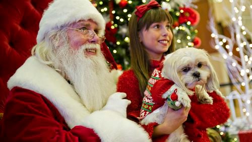 Bailey and her owner Katelyn Vetro take a photo with Santa at Town Center at Cobb in Kennesaw on Nov. 30, 2014. Visitors to Town Center at Cobb, The Mall of Georgia, Northlake and Lenox Square malls had the opportunity to visit with Santa and bring their pets along for a photo. JONATHAN PHILLIPS / SPECIAL
