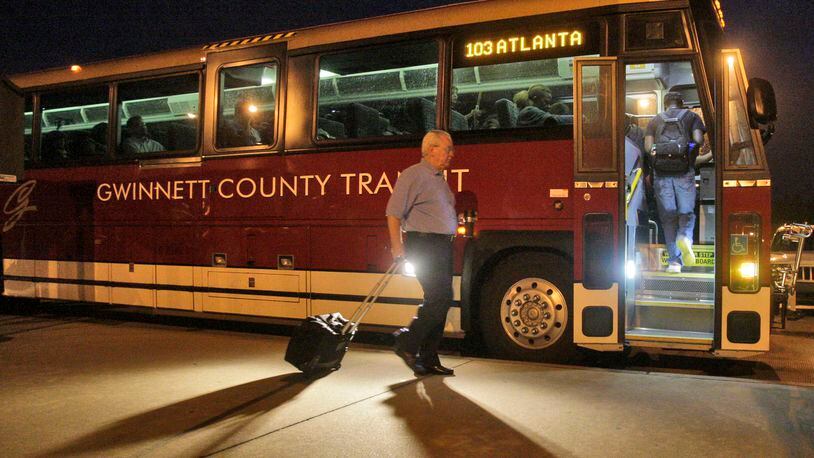 In this 2011 file photo, riders board the express bus to downtown Atlanta in the early morning at the Sugarloaf Mills Park & Ride in Gwinnett County. Bob Andres/bandres@ajc.com