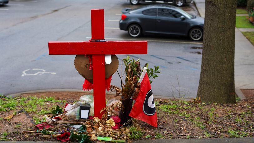 A memorial honoring the site of the car crash that ended the lives of Georgia offensive lineman, Devin Willock, 20, and UGA recruiting analyst, Chandler LeCroy, 24, sits at the intersection of Barnett Shoals and Stroud roads, east of downtown Athens, Georgia, on Thursday, March 2, 2023. (Olivia Bowdoin / AJC). 