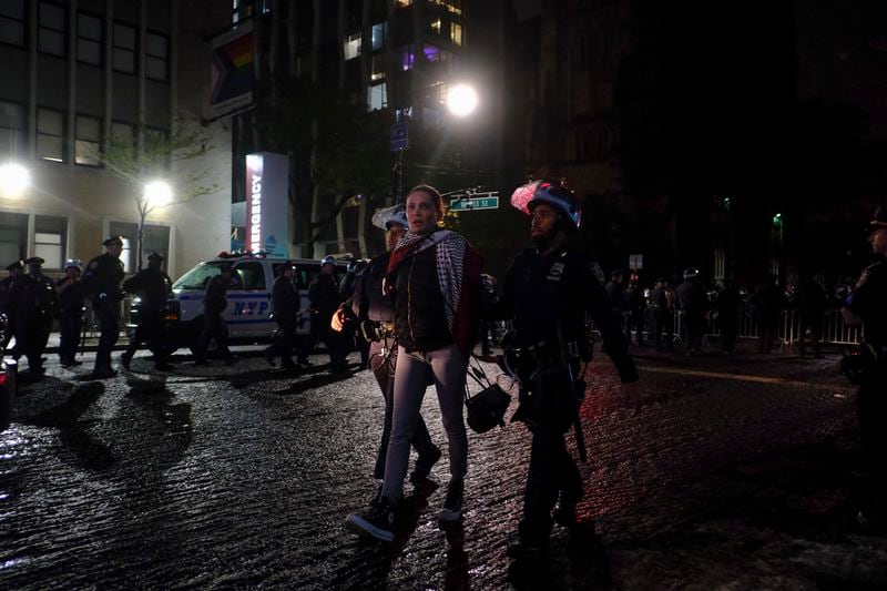 New York Police officers escort a protester outside the Columbia University campus, Tuesday, April 30, 2024, in New York. (AP Photo/Julius Motal)