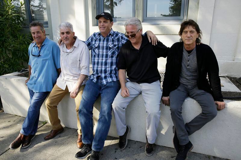 FILE - The Waldos, from left, Mark Gravitch, Larry Schwartz, Dave Reddix, Jeffrey Noel and Steve Capper sit on a wall they used to frequent at San Rafael High School in San Rafael, Calif., April 13, 2018. Marijuana advocates are gearing up for Saturday, April 20, 2024. Known as 4/20, marijuana's high holiday is marked by large crowds gathering in parks, at festivals and on college campuses to smoke together. (AP Photo/Eric Risberg, File)