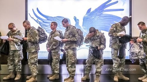 Fort Benning soldiers at Hartsfield-Jackson heading home for the holidays for two weeks. Credit: John Spink / AJC