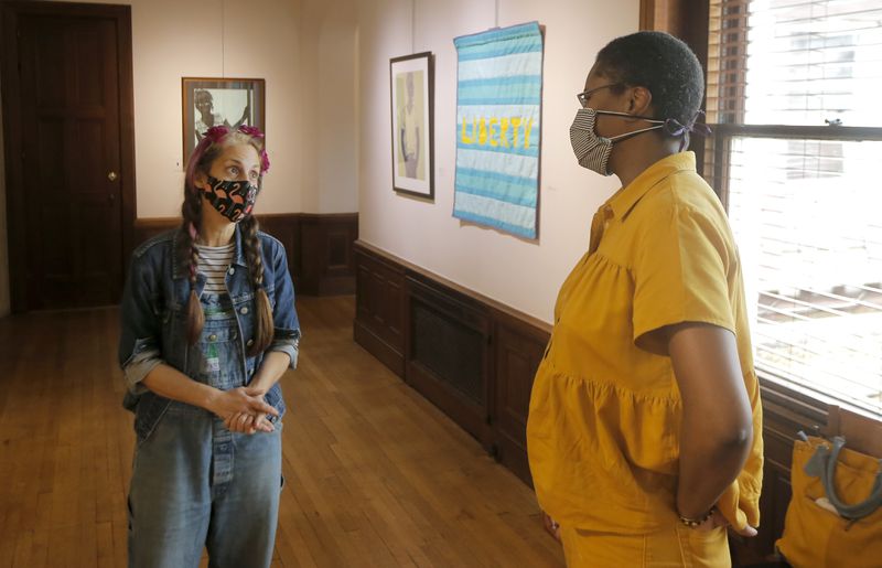 Artist Jerushia Graham speaks with art teacher Brook Hewitt about her new exhibit, “Freedom Isn’t Free,” at Callanwolde Fine Arts Center in Atlanta on Tuesday, July 20, 2021. The show runs from July 15 to Sept. 2. (Christine Tannous / christine.tannous@ajc.com)