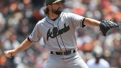 The Braves’ R.A. Dickey pitches against the San Francisco Giants at AT&T Park on Sunday. He allowed seven runs, six earned, in the first three innings. (Photo by Thearon W. Henderson/Getty Images)