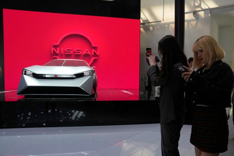 Visitors stand near a concept car from Nissan during Auto China 2024 held in Beijing, Thursday, April 25, 2024. Global automakers and EV startups unveiled new models and concept cars at China's largest auto show on Thursday, with a focus on the nation's transformation into a major market and production base for digitally connected, new-energy vehicles. (AP Photo/Ng Han Guan)