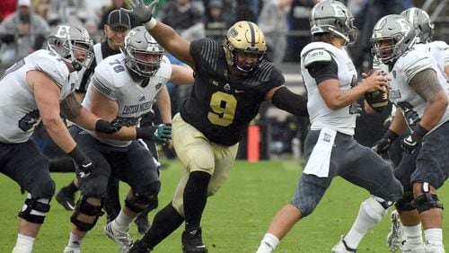 Purdue's Lorenzo Neal sacks Eastern Michigan's Tyler Wiegers.(Photo: Frank Oliver for the Journal & Courier)