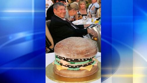 In this Aug. 21, 2008 file photo Big Mac creator Jim Delligatti sits behind a Big Mac birthday cake at his 90th birthday party in Canonsburg, Pa.