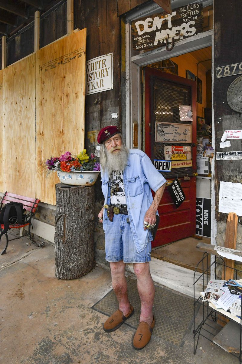 Dent "Wildman" Myers stands outside his boarded up Confederate-era memorabilia shop, before demonstrators arrive to protest, Friday, June 5, 2020, in Kennesaw. Friends of his boarded up the shop out of fear for his life and property after riots and destruction have been seen across Atlanta and nation carried out by protesters. JOHN AMIS FOR THE ATLANTA JOURNAL-CONSTITUTION