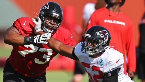 Falcons rookie linebacker Yurik Bethune (right) rushes against tackle Matt Gono (left) on the first day in pads at training camp Wednesday, July 24, 2019, in Flowery Branch.