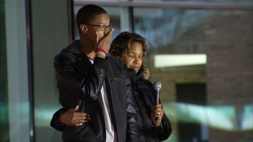 Lisa Barney’s son Robert joined her at the Riverdale Town Center as she thanked the crowd that came out to share stories about her husband Tues., Feb. 17, 2016. (Credit: Channel 2 Action News)