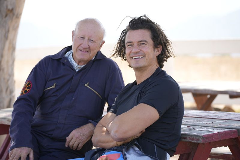 This image released by Peacock shows Chris Copeland and Orlando Bloom in an episode of the television series "Orlando Bloom: To the Edge." (Casey Durkin/Peacock via AP)