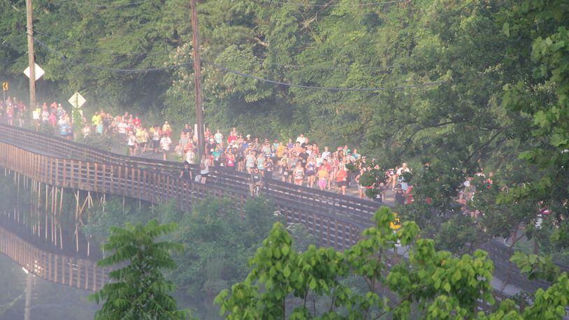 Participants race across the river in the Chattahoochee Nature Center's annual Possum Trot 10K. (Courtesy Chattahoochee Nature Center)