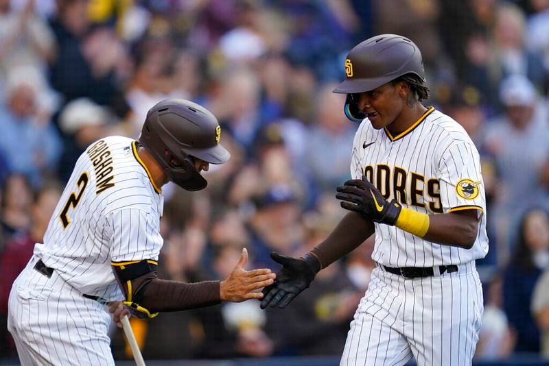 San Diego Padres' C.J. Abrams, right, is greeted by Trent Grisham after hitting a home run during the second inning of the team's baseball game against the Atlanta Braves, Thursday, April 14, 2022, in San Diego. (AP Photo/Gregory Bull)
