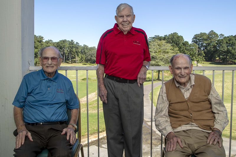Twin brothers James, left, and Jennings Watkins, right, sit for a portrait with their friend Bo Cline, center, during the Golf Classic for CURE Childhood Cancer Tournament at the Oaks Golf Course in Covington. (Alyssa Pointer/Atlanta Journal Constitution)