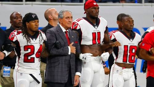 Atlanta Falcons owner Arthur Blank stands with his players during the national anthem before an NFL football game against the Detroit Lions, Sunday, Sept. 24, 2017, in Detroit. (AP Photo/Rick Osentoski)