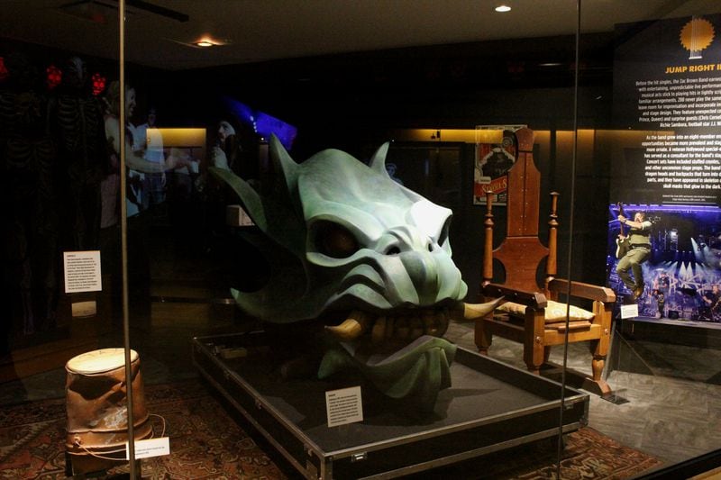 The band's dragon head from their last tour is the centerpiece of the exhibit. Photo: Melissa Ruggieri/AJC