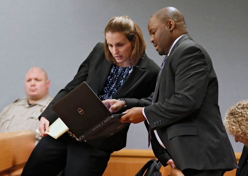 Emily Gilbert and Brad Gardner, state capital public defenders, confer on April 26, 2019, while presenting a motion to meet privately with Judge George Hutchinson outside the presence of the prosecution at Gwinnett County Superior Court. 