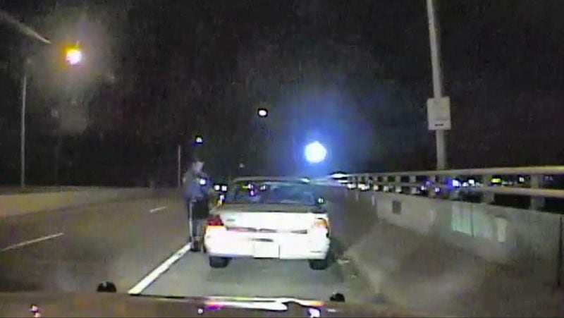 In this image taken from a Neptune City, N.J., police officer's dashboard camera early Dec. 3, 2016, an officer examines the vehicle belonging to Sarah Stern, 19, after it was found abandoned on the Route 35 Bridge in Belmar. Stern's friend and former classmate, Liam McAtasney, is on trial, accused of strangling Stern and throwing her body from the bridge. The 21-year-old McAtasney faces life in prison if convicted.