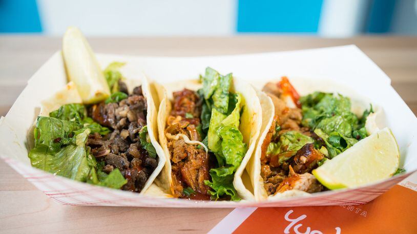 Spicy pulled-pork, Asian rib-eye beef, and chicken tacos at Yumbii. CONTRIBUTED BY MIA YAKEL