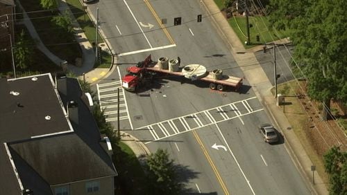 Atlanta police are at the scene of a crash between a motorcycle and a tractor-trailer truck on Lenox Road that has left at least one person dead.