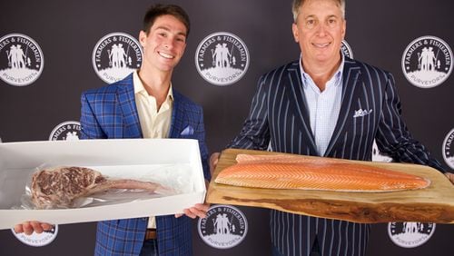 Ben (left) and Kirk Halpern show off a fresh Norwegian salmon and a Waygu tomahawk steak. 
Courtesy of Farmers & Fishermen Purveyors