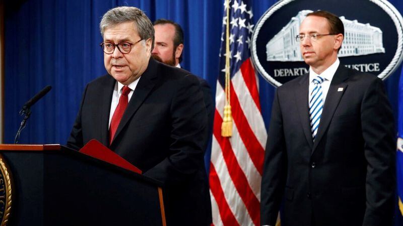 Attorney General William Barr speaks alongside Deputy Attorney General Rod Rosenstein, right, and Deputy Attorney General Ed O'Callaghan, rear left, about the release of a redacted version of special counsel Robert Mueller's report during a news conference, Thursday, April 18, 2019, at the Department of Justice in Washington. 