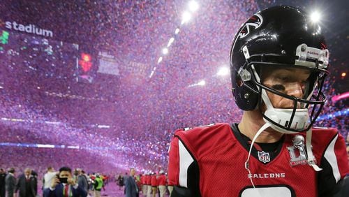 A dejected Matt Ryan walks off the field as the confetti falls to celebrate the Patriots&#039; 34-28 in the 2017 Super Bowl.