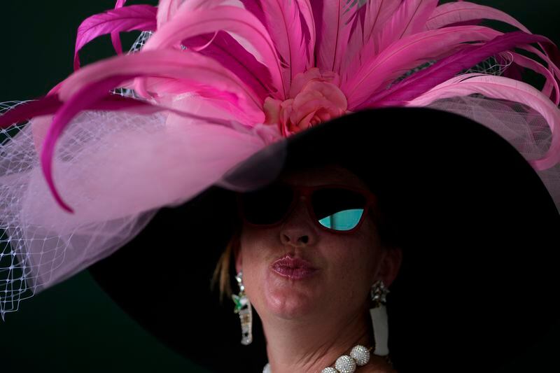 A race fan walks through the grounds of Churchill Downs before the 150th running of the Kentucky Derby horse race Saturday, May 4, 2024, in Louisville, Ky. (AP Photo/Charlie Riedel)