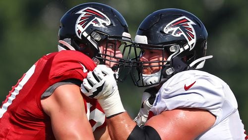 Falcons defensive end John Cominsky (left) rushes against tackle Jake Matthews during team practice Monday, July 29, 2019, in Flowery Branch.