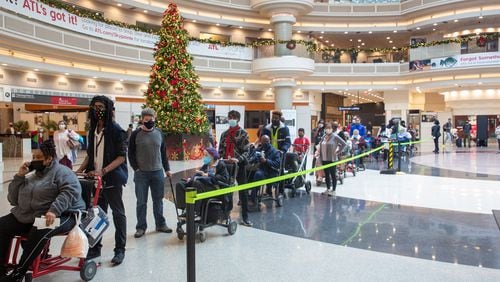 People wait in line to go through the security checkpoint at Hartsfield-Jackson International Airport on Monday, December 27, 2021.  STEVE SCHAEFER FOR THE ATLANTA JOURNAL-CONSTITUTION