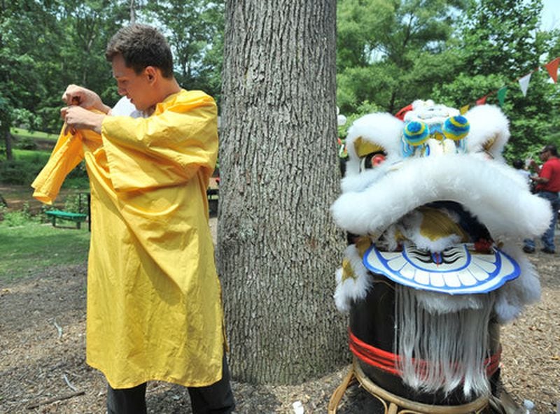 Nick Mancuso, of Atlanta Lion Dancing Troupe, gets ready for Lion Dance performance at Perkerson Park Sunday.