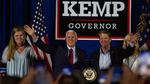 Vice President Mike Pence and  Secretary of State Brian Kemp talk at a rally in Macon GA Saturday, July 21, 2018. Vice President Mike Pence endorsed Brian Kemp for Governor during the event. STEVE SCHAEFER / SPECIAL TO THE AJC