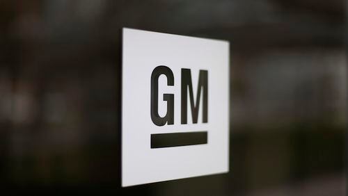 This Friday, May 16, 2014, file photo, shows the General Motors logo at the company's world headquarters in Detroit. In another tweet targeting GM, President-elect Donald Trump is threatening to slap a tax on the U.S. automaker for importing compact cars to the U.S. from Mexico. But GM makes the vast majority of compact Chevrolet Cruzes at a sprawling factory complex in Lordstown, Ohio, near Cleveland. (AP Photo/Paul Sancya, File)
