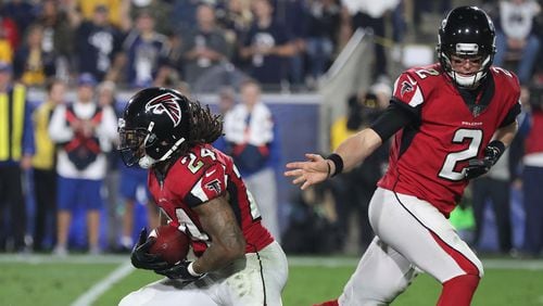 Matt Ryan hands off to Devonta Freeman during the second half against the Rams in their NFL Wild Card Game on Saturday, January 6, 2018, in Los Angeles.    Curtis Compton/ccompton@ajc.com