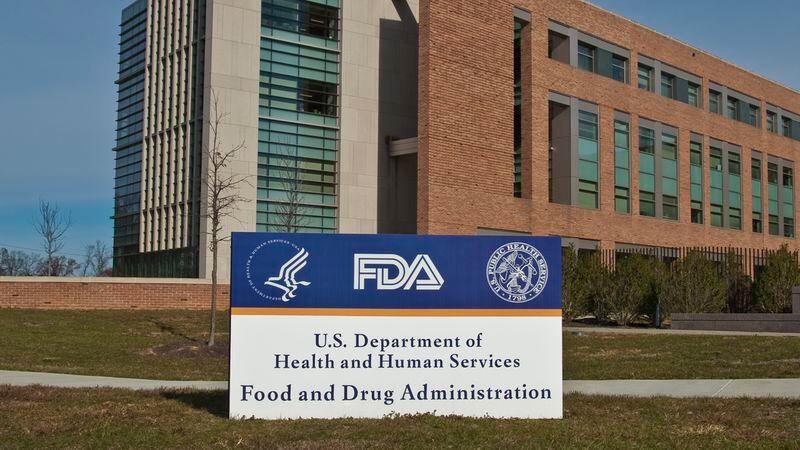 FDA Building 21 stands behind the sign at the campus's main entrance and houses the Center for Drug Evaluation and Research. The government shut down has led to reduced FDA food inspections.