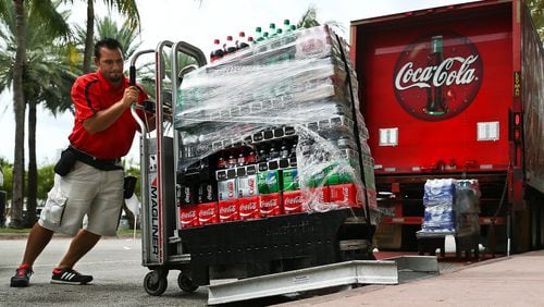Scott McIntyre/Bloomberg An employee delivers cases of Coca-Cola brand sodas in Miami Beach, Florida, on Oct. 24, 2016. (MUST CREDIT: Scott McIntyre/Bloomberg)