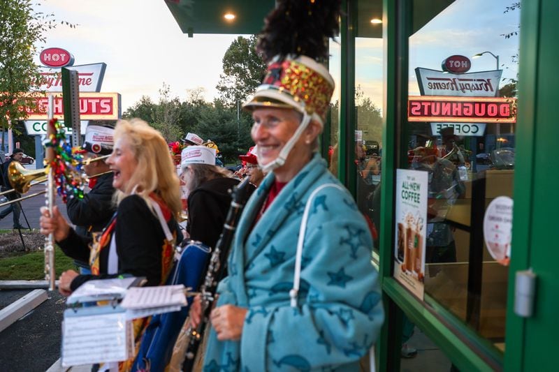 The Seed & Feed Marching Abominable band play during the Oct. 10 grand reopening of the Krispy Kreme on Ponce De Leon Avenue in Midtown.  (Arvin Temkar / arvin.temkar@ajc.com)