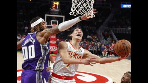 Atlanta Hawks guard Jeremy Lin (7) scores against Sacramento Kings center Willie Cauley-Stein (00) during the first half of an NBA basketball game Thursday, Nov. 1, 2018, in Atlanta. (AP Photo/John Bazemore)