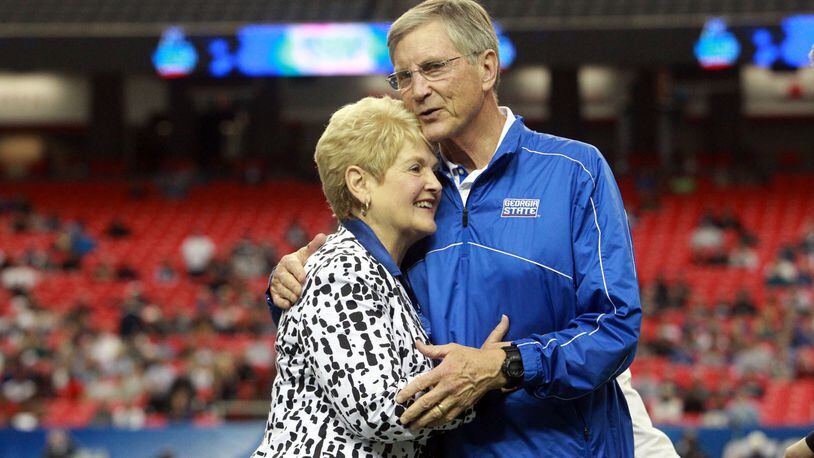 In this 2012 AJC file photo, Georgia State University coach Bill Curry hugs his wife Carolyn as he is honored in his final home game.