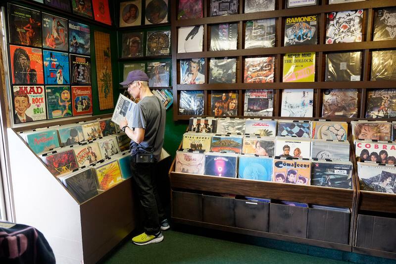 Michael Iffland checks out some Beatles vinyl at Tracks In Wax record shop, Thursday, April 18, 2024, in Phoenix. Special LP releases, live performances and at least one giant block party are scheduled around the U.S. Saturday as hundreds of shops celebrate Record Store Day amid a surge of interest in vinyl and the day after the release of Taylor Swift's latest album. (AP Photo/Ross D. Franklin)