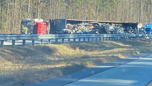 An overturned tractor-trailer is blocking the southbound lanes of Ga. 400 in Forsyth County.