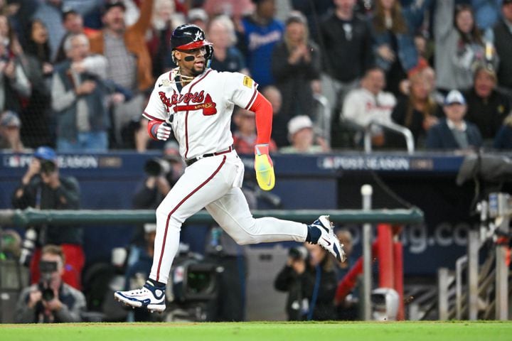 Atlanta Braves’ Ronald Acuna Jr. (13) scores on a Philadelphia Phillies error and a single by teammate Ozzie Albies during the sixth inning of NLDS Game 2 in Atlanta on Monday, Oct. 9, 2023.   (Hyosub Shin / Hyosub.Shin@ajc.com)