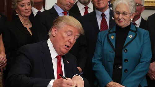 President Donald Trump signs an executive order Thursday as U.S. Sen. Rand Paul, R-Ky., Vice President Mike Pence and U.S. Rep. Virginia Foxx, R-N.C., look on during an event in the Roosevelt Room of the White House. President The executive order loosens restrictions in the Affordable Care Act “to promote healthcare choice and competition.” (Photo by Alex Wong/Getty Images)